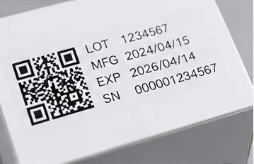 Close-up of a traceability label with QR and serial information on healthcare packaging
