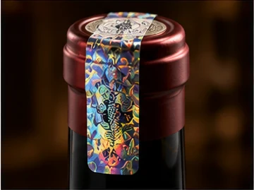Holographic security seal applied across the cap and neck of a spirits bottle